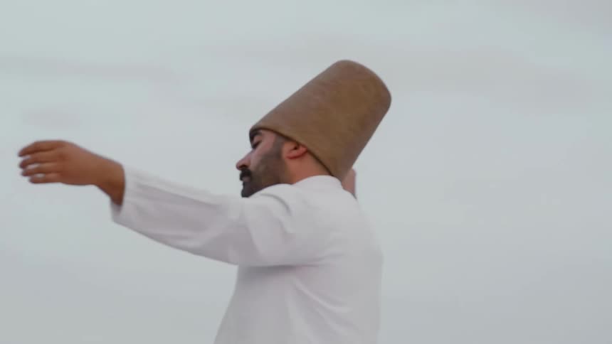 A man demonstrates the traditional dance of the whirling dervish