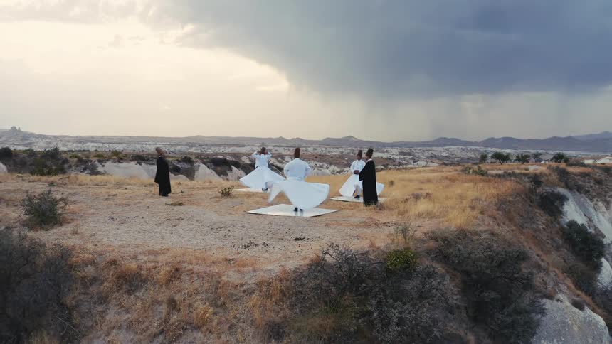 Sufi muslims perform the mystical ritual spinning dance amidst breathtaking mountaintop scenery
