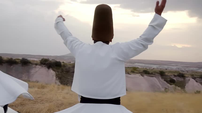 Whirling dervishes spin with their eyes closed and hands lifted in reverence to God