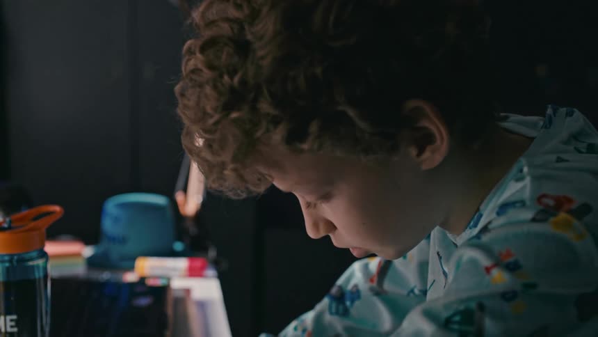 A young boy stares at a calendar