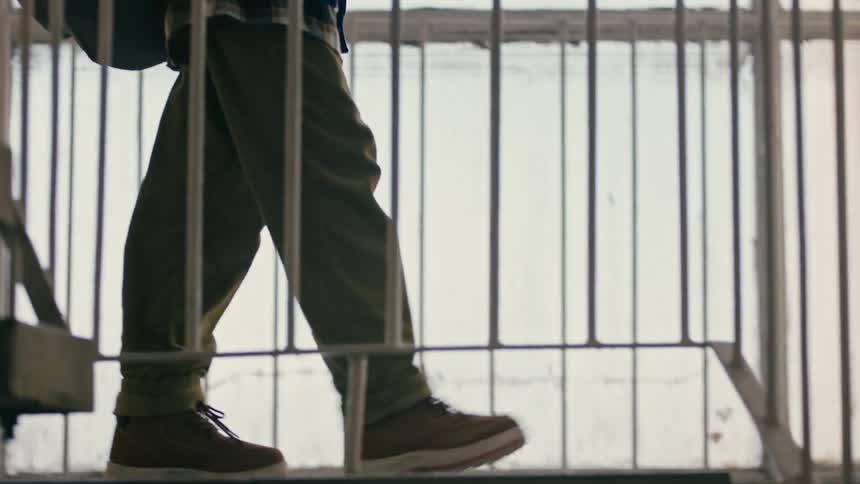 Little boy walking down the stairs of a building