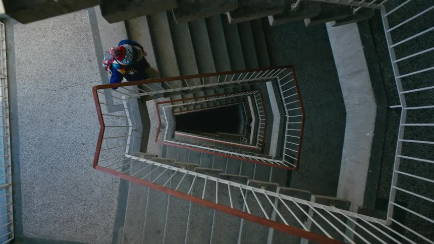 Little girl walking down the stairs of a building