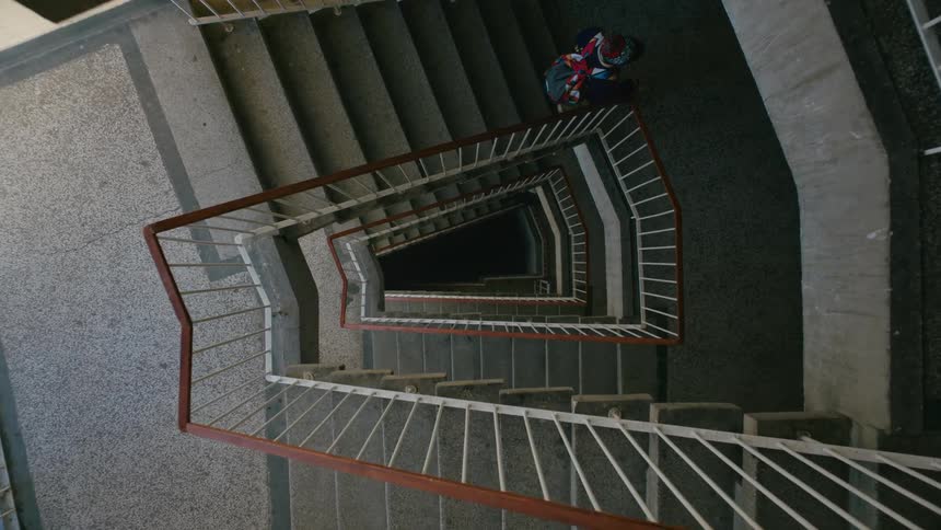 A boy climbs down the staircase