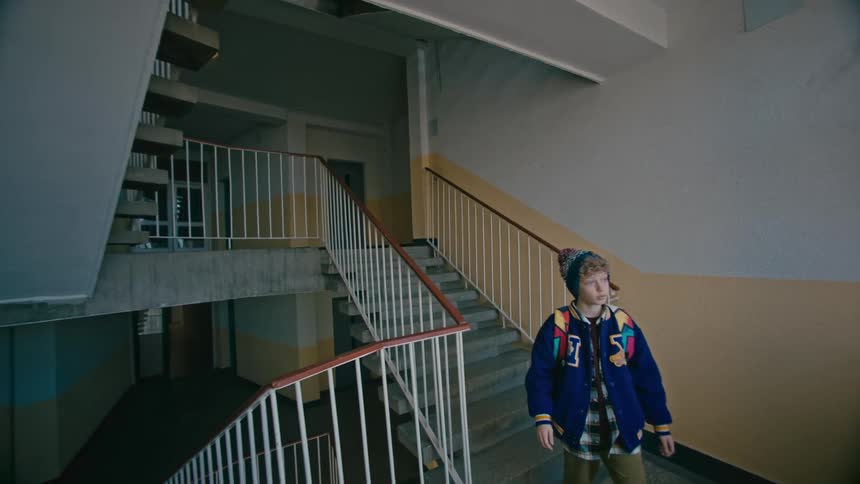A clip of a boy walking down the staircase