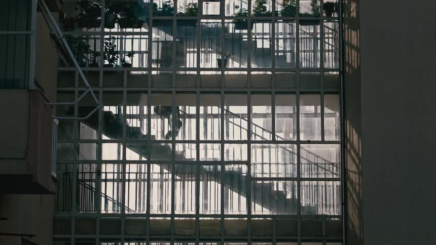 A person is going down the steps of a place with several bars