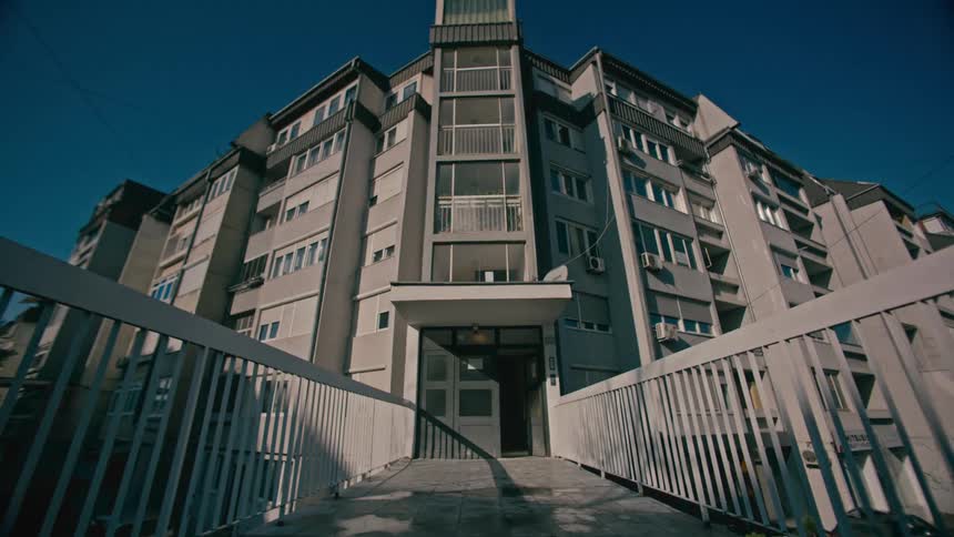 A walkway to an austere corner building