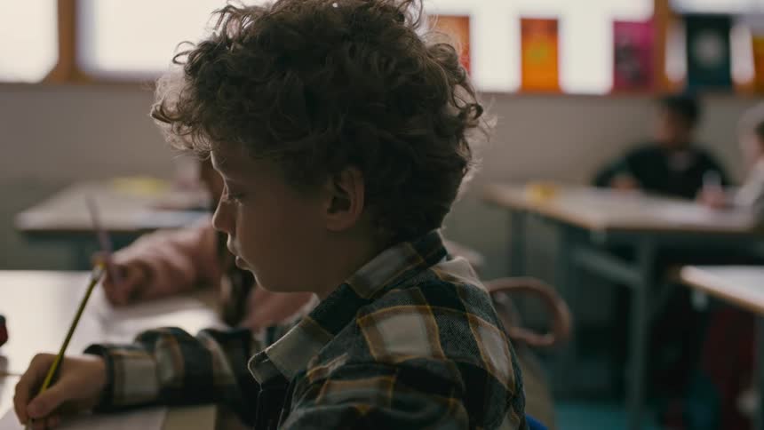 A boy studying at a school during the day