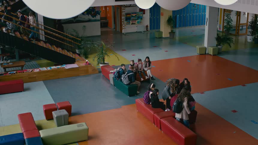 A group of students gather in the common areas at school