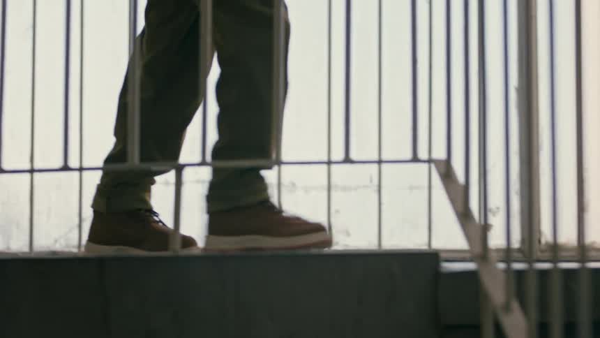A child walks down a set of stairs their hand against the railing