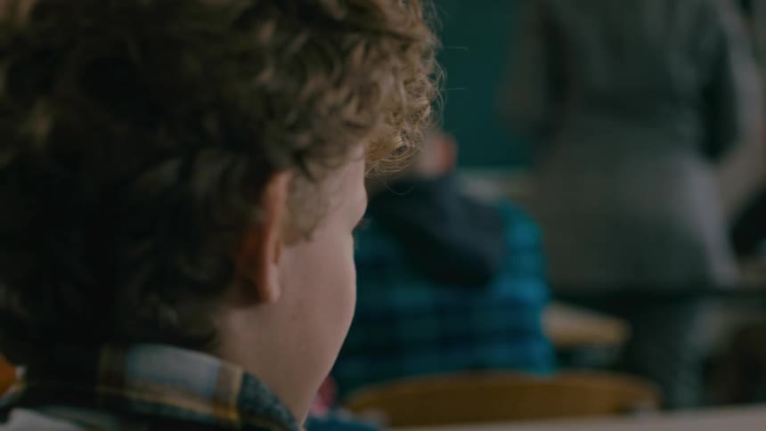 A teacher and some students in a room together
