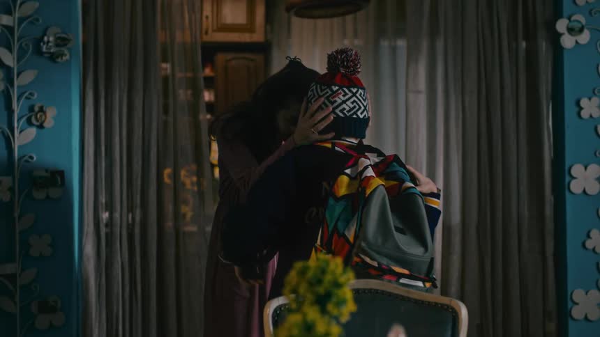 A mother says goodbye to her son as he leaves for school