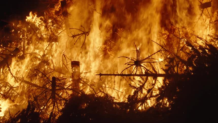 Flames consume a pile of wood