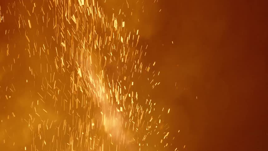 A raging fire throws off smoke and sparks