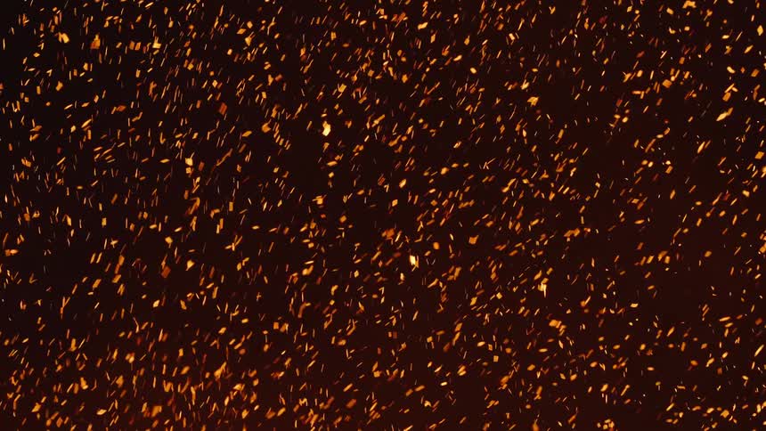 Several orange spark particles moving upwards