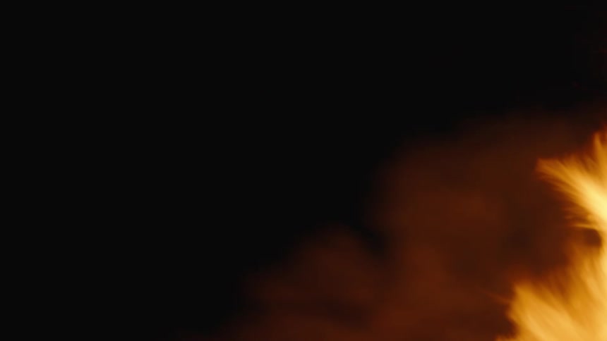 A big fire burns outdoors at night