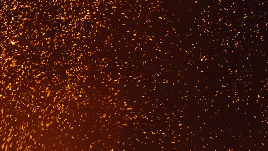 Bright golden sparks floating on a dark background