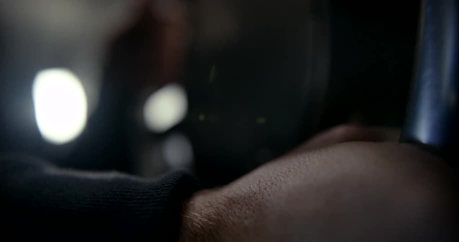 Close up of a hand sliding a metal sheet