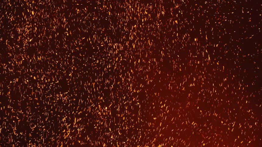 Glowing embers move as they float in the darkness
