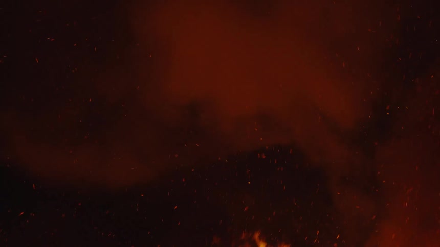 Strong fire with smoke rising at night