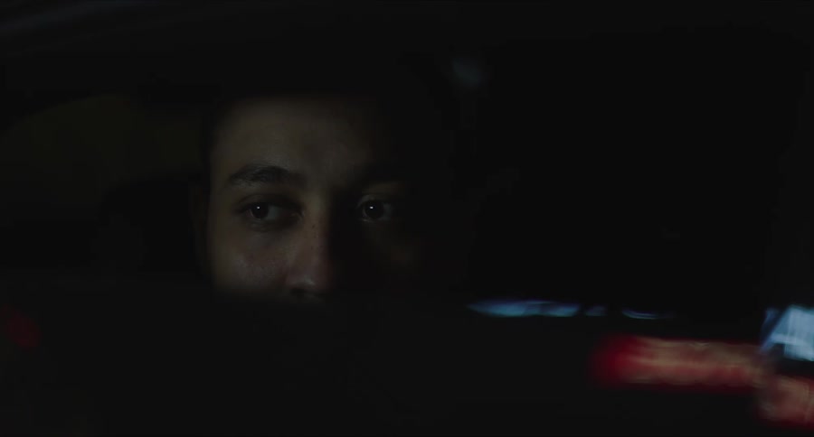 A person stares fearfully outside