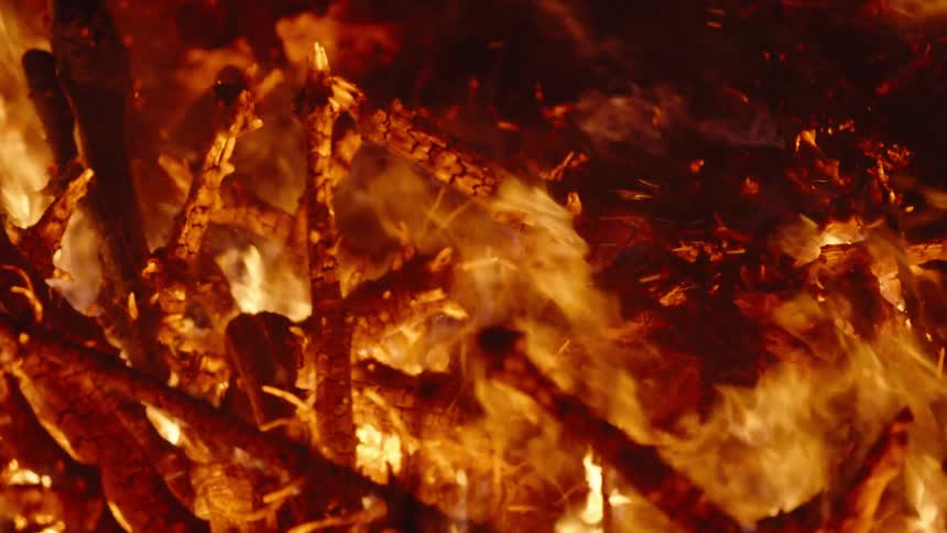 Flames consume a pile of wooden sticks