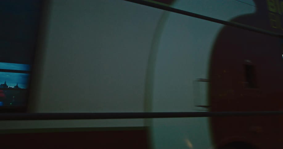 Closeup on public transport with a view of a metropolis at night