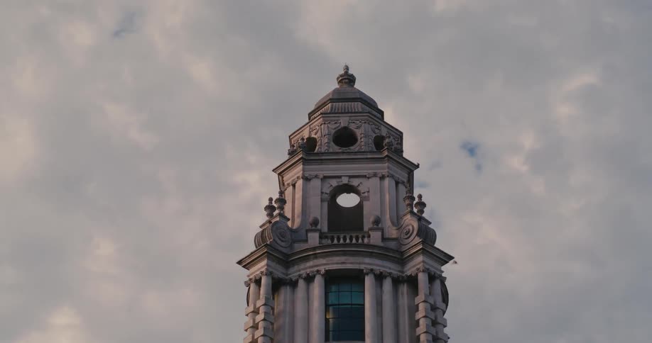 Tower of a church with bell in a cloudy sky