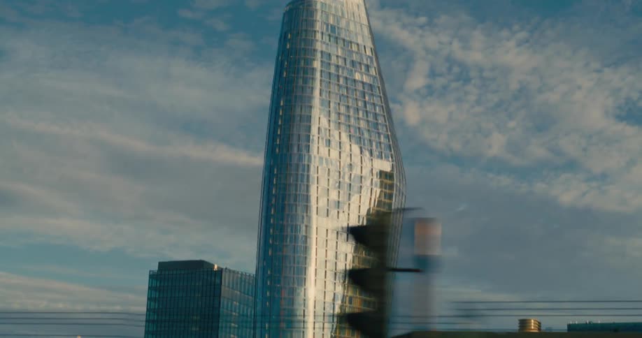 Modern mirrored skyscraper in the middle of a metropolis