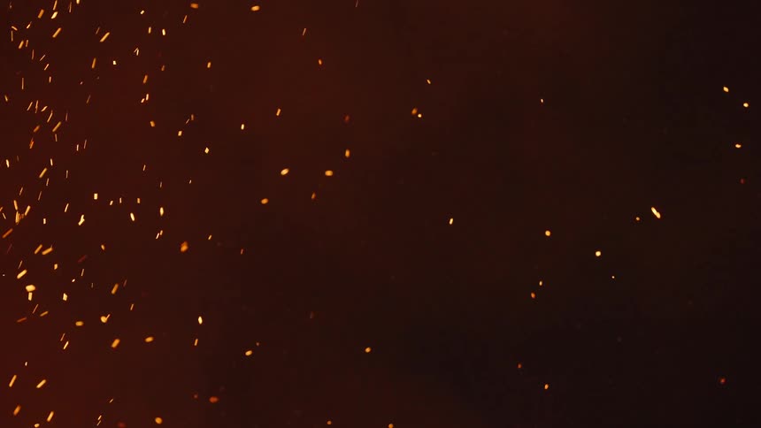 Smoke and fire shrapnel flying at night
