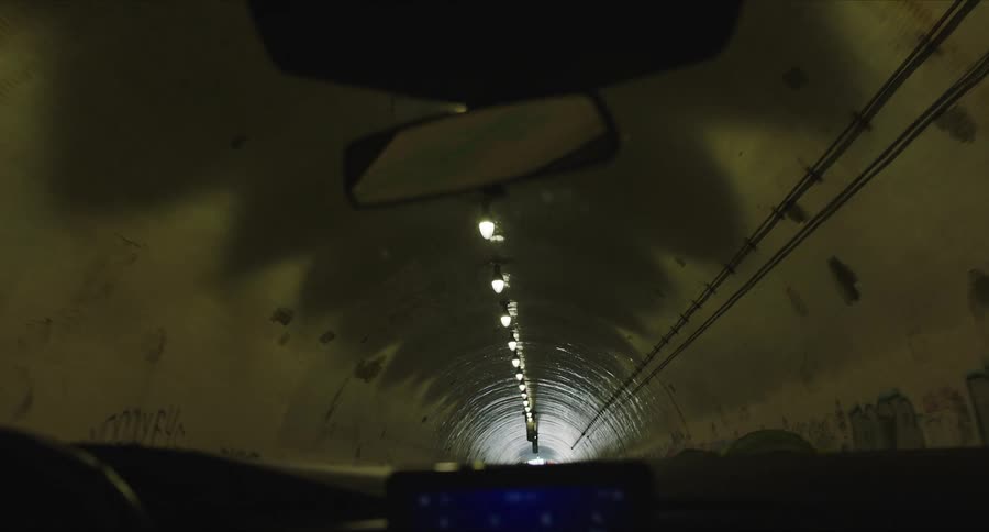 View of car windshield going through a tunnel