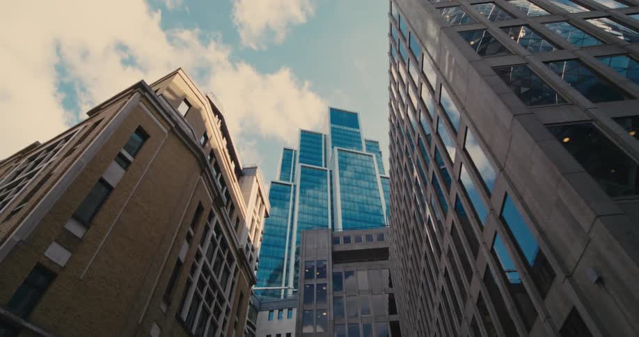 A city center with several tall buildings and large glass windows