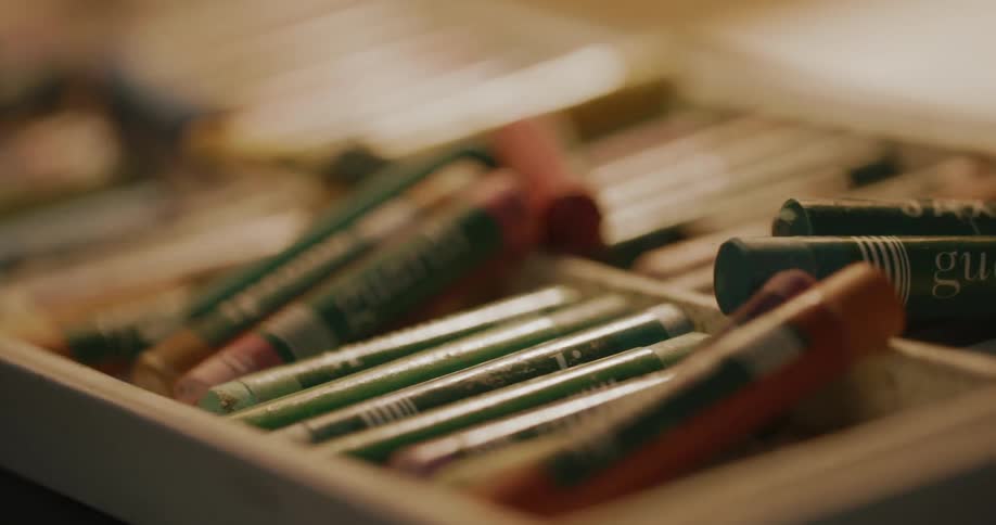 Closeup on a wooden box with a crayon