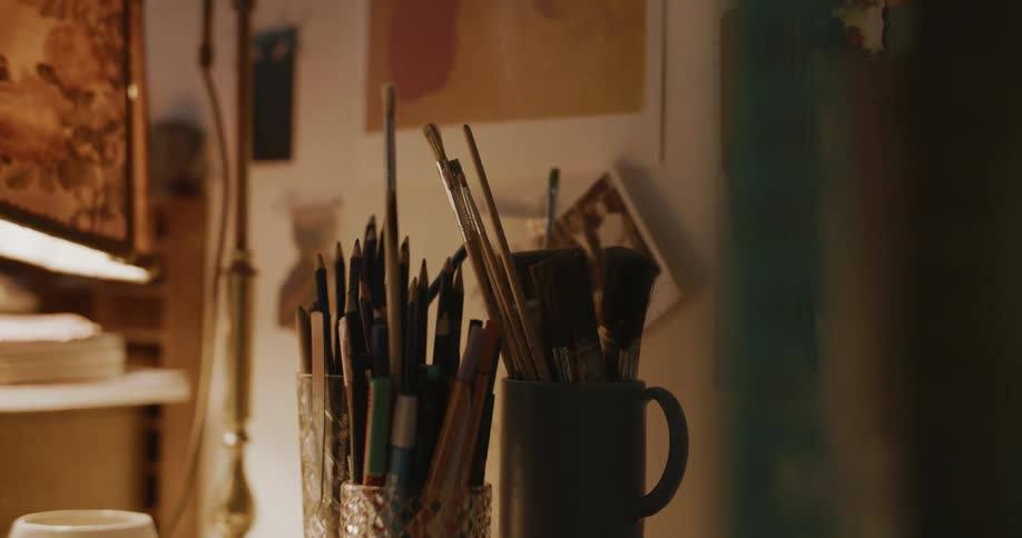 Pencils and brushes on the table in an art studio