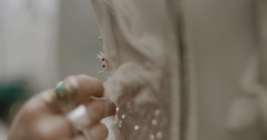 A person sewing a piece of clothing in a fashion studio