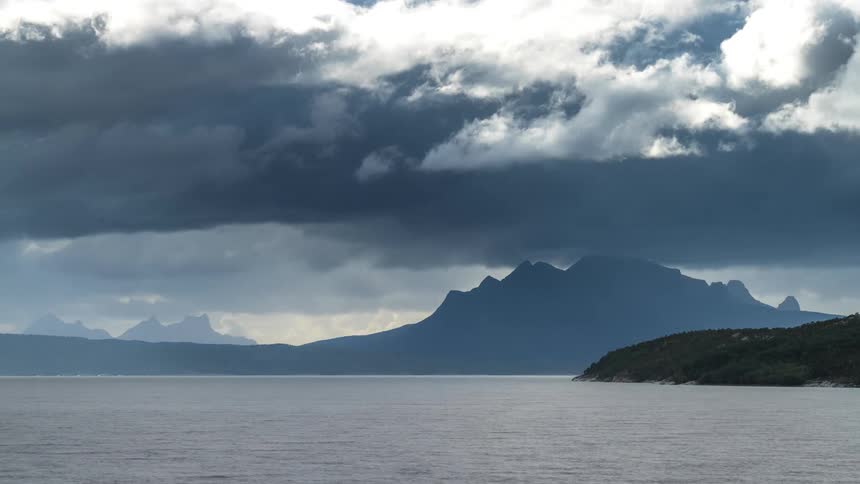 Sea landscape with mountains and clouds passing by in timelapse