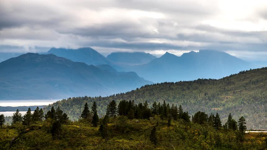Panorama of a landscape of mountain ranges with forests and lakes