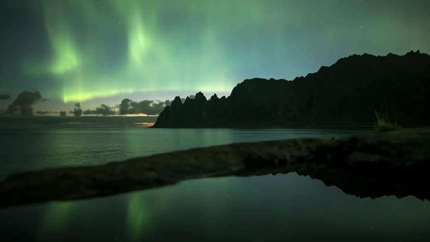 Northern lights lighting up the sky on a beach at night