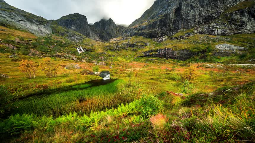 A clip of a green field closer to the mountain