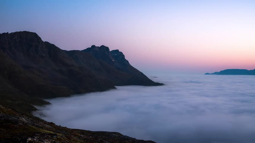 Aerial of rocky mountains during cloudy dawn