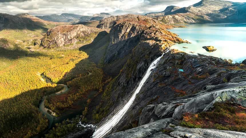 A lake pours off the mountain