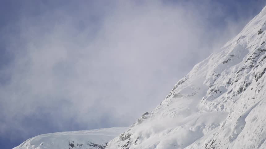 A snow avalanche on the mountain during the day