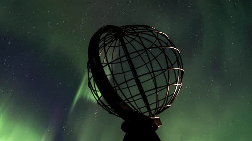 Object of a chrome globe overlooking the sky in northern lights