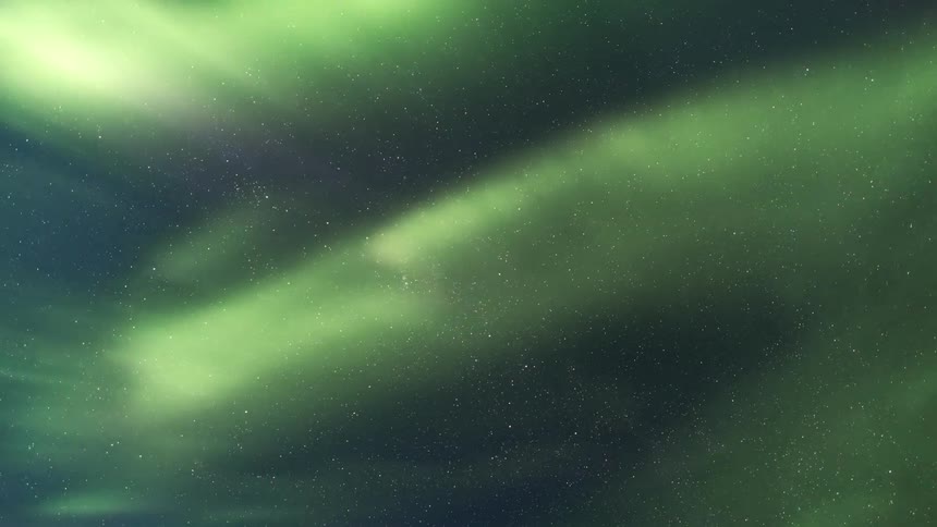 The northern lights dances across the starry night sky