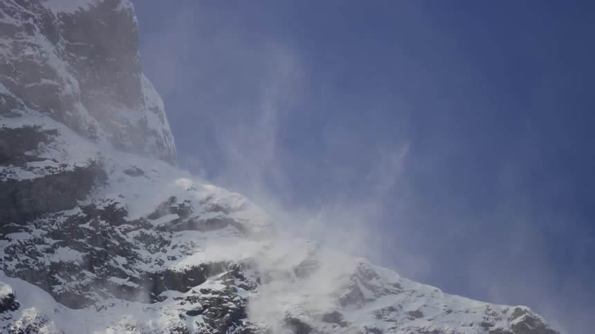 Mountain covered by snow in a cloudless blue sky
