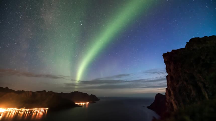Landscape of a sky with aurora borealis over the sea and mountain