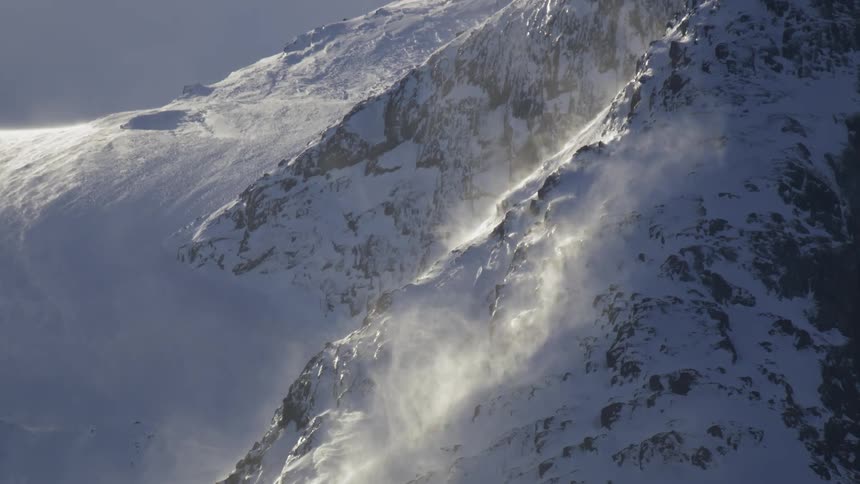 Mountain covered by snow and solar reflection