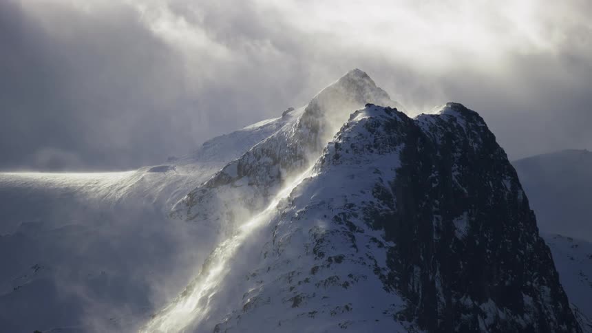 Mist flows off the mountain