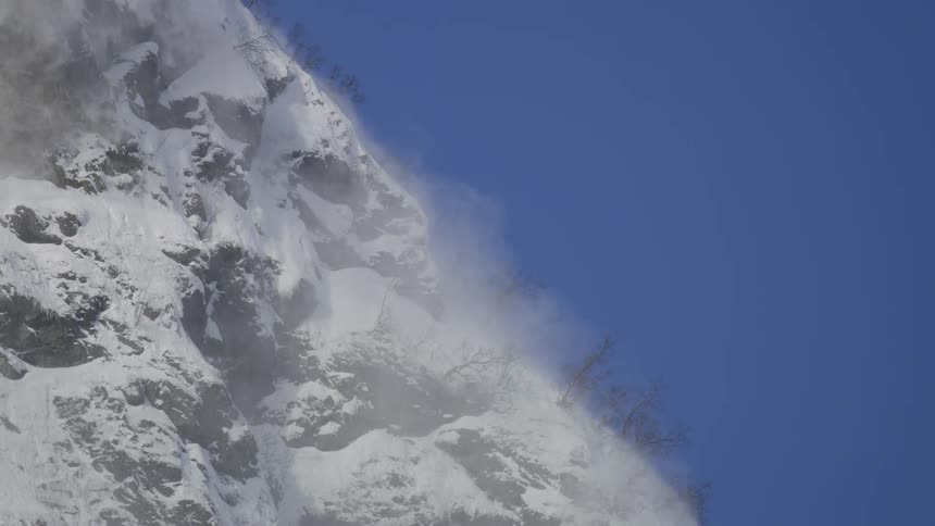 A snow avalanche on a mountain during the day
