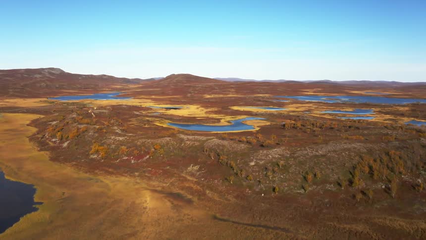 A desert region with many pools of water and a small lake