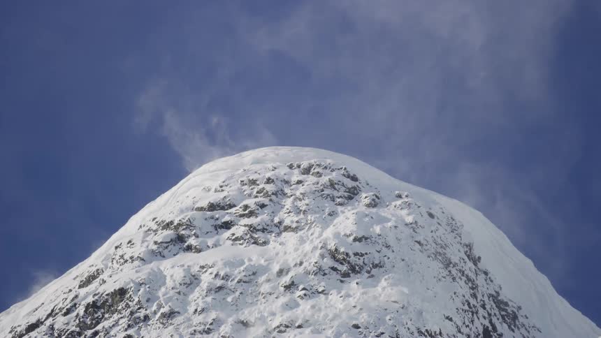 Top of a rocky mountain covered in snow during winter